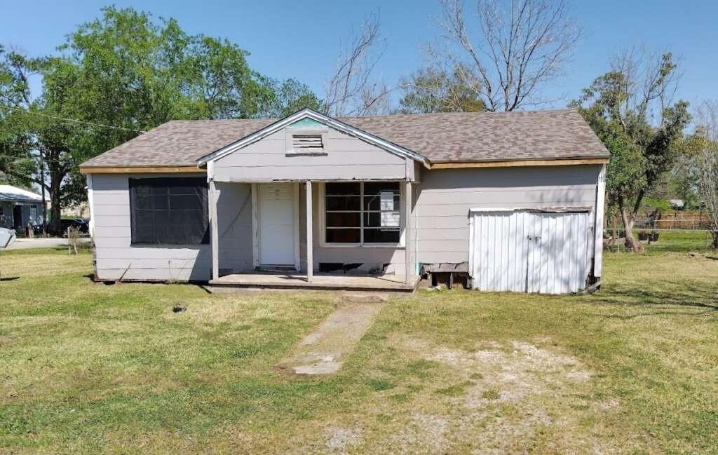 a front view of a house with a garden and yard