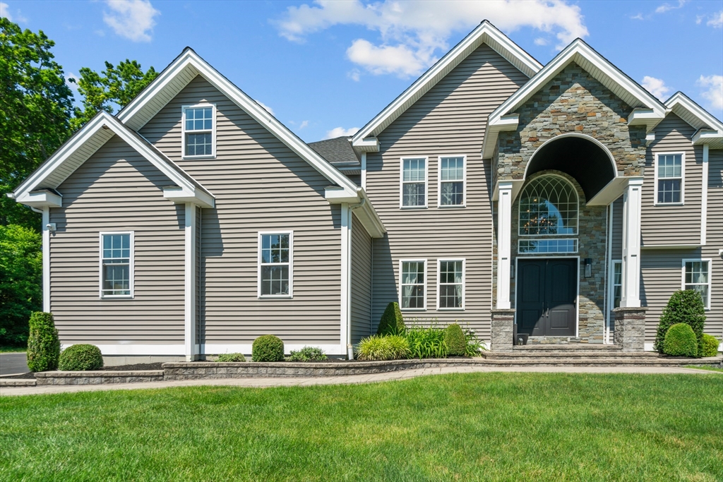 a front view of a house with a yard