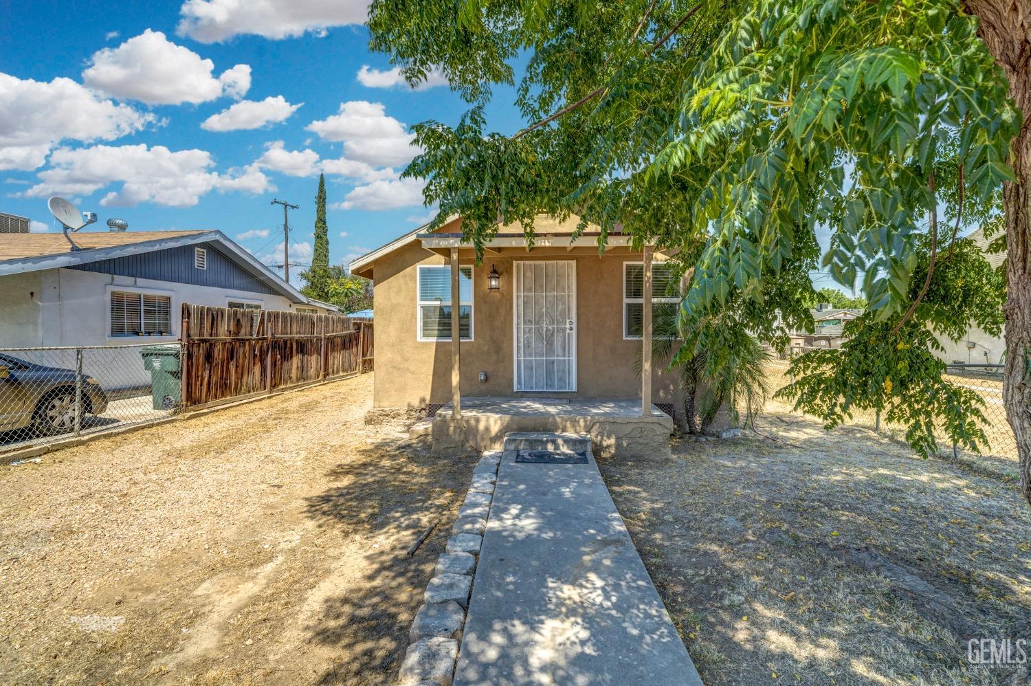 a view of a house with a tree in front