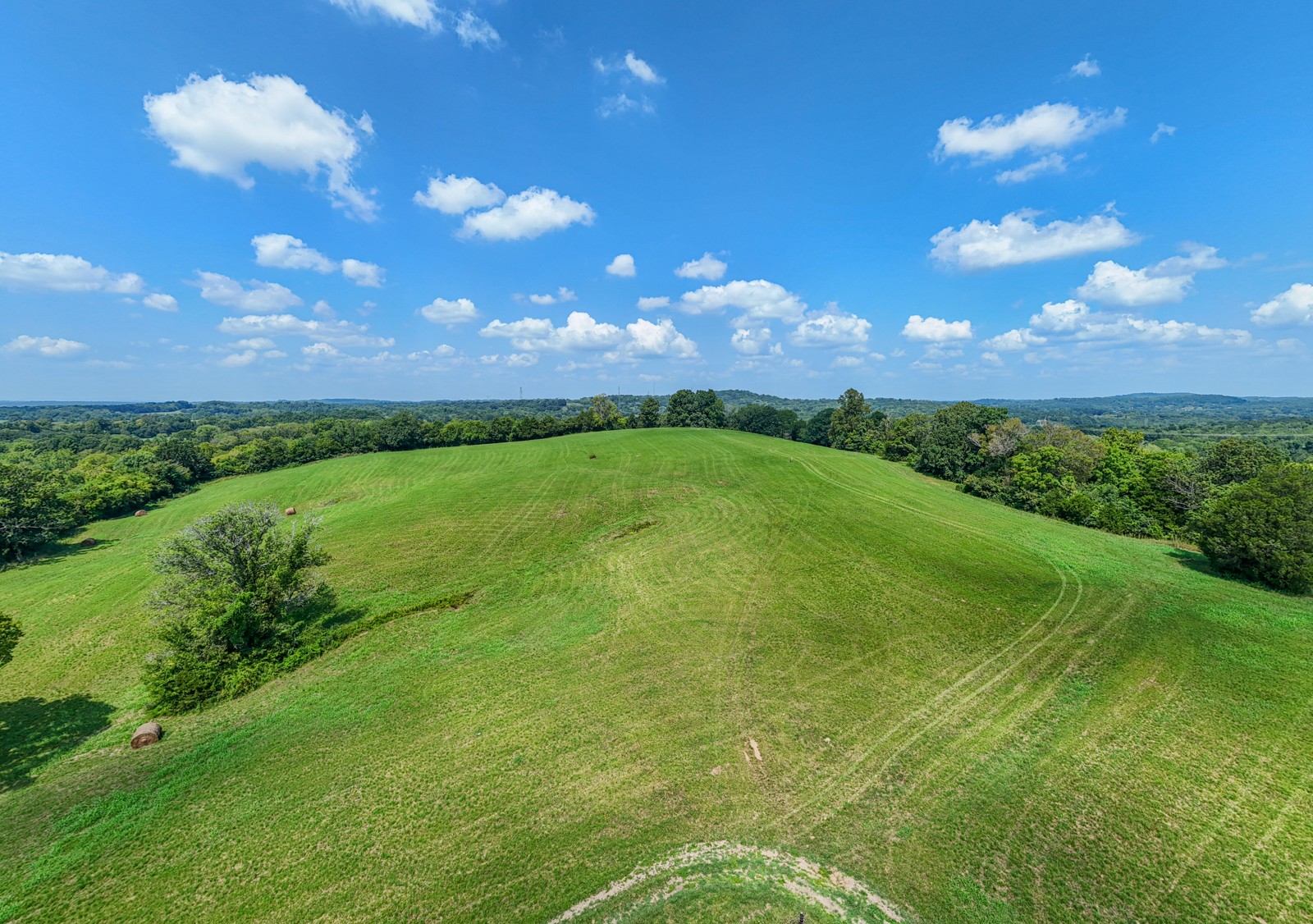 a view of a golf course with huge green field and grass