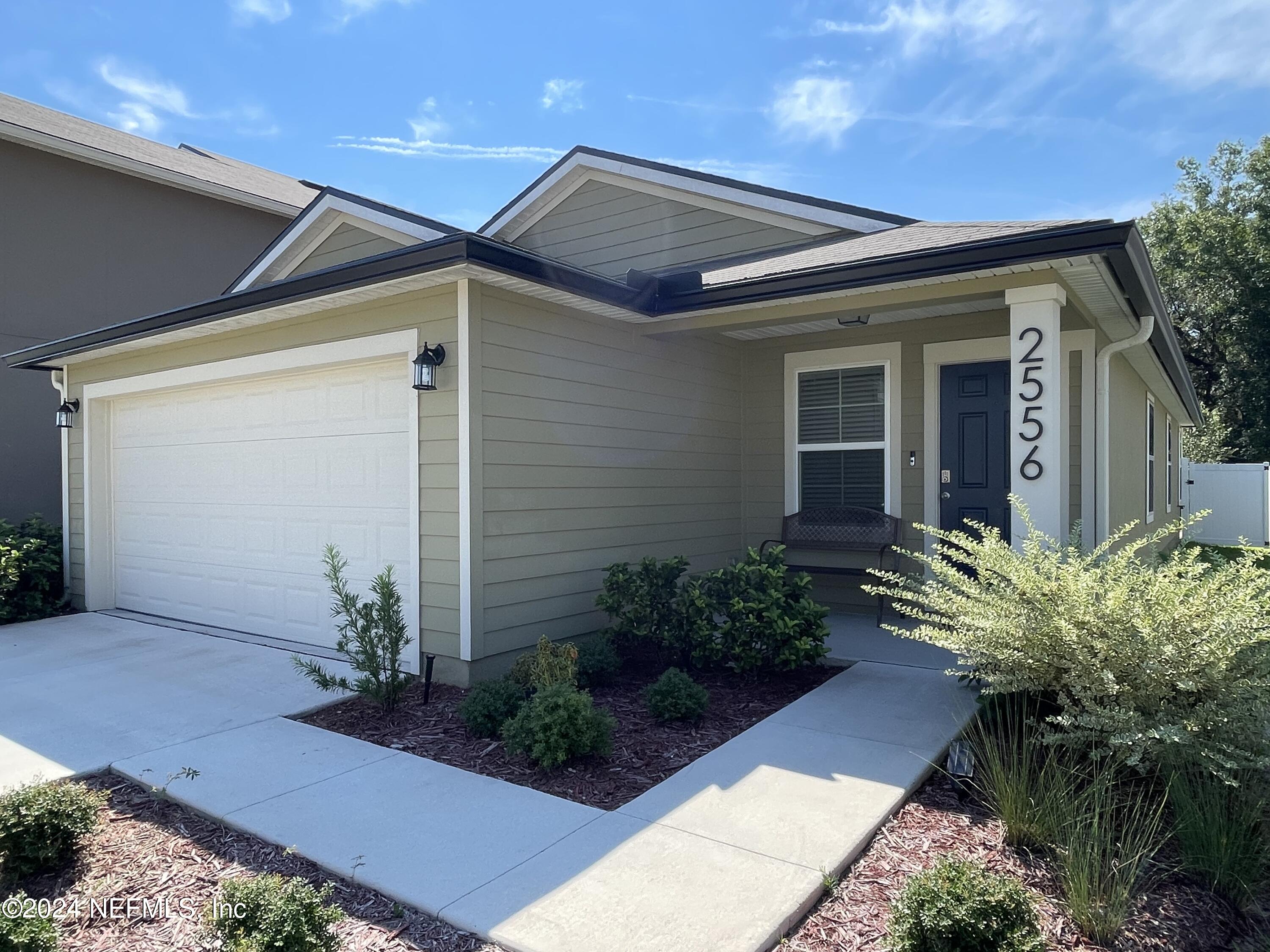 a front view of house with yard and outdoor seating