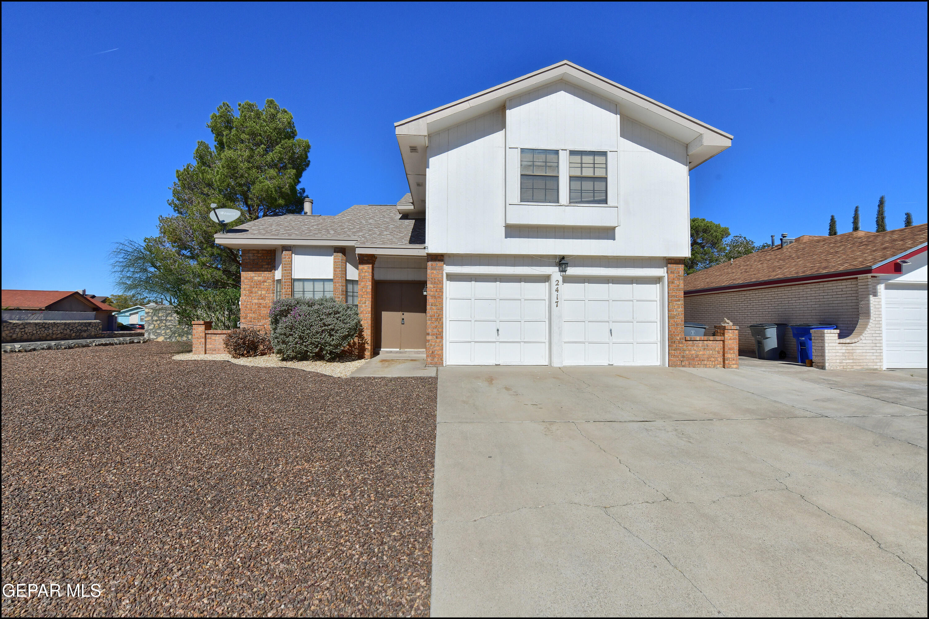 a view of a house with a yard and garage