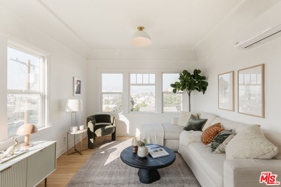 a living room with furniture and a large window