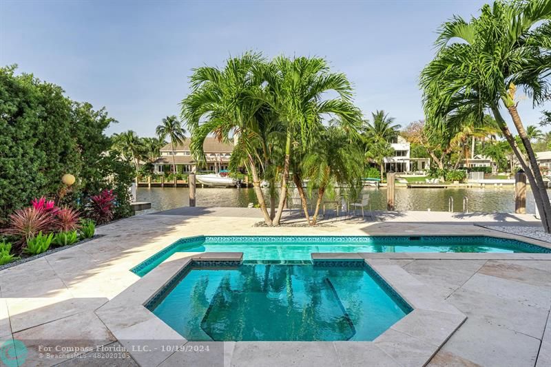 a view of yard with swimming pool and trees