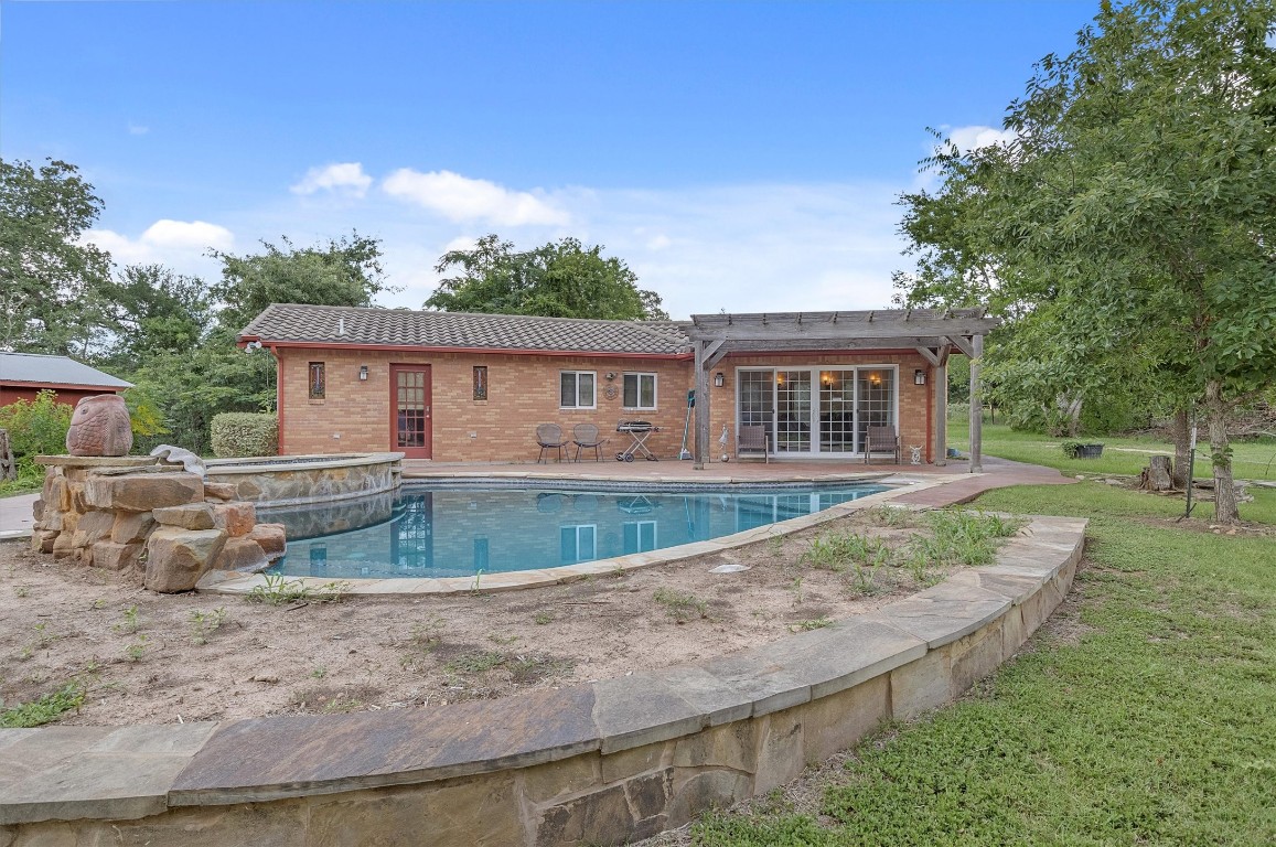 a view of a house with backyard and sitting area