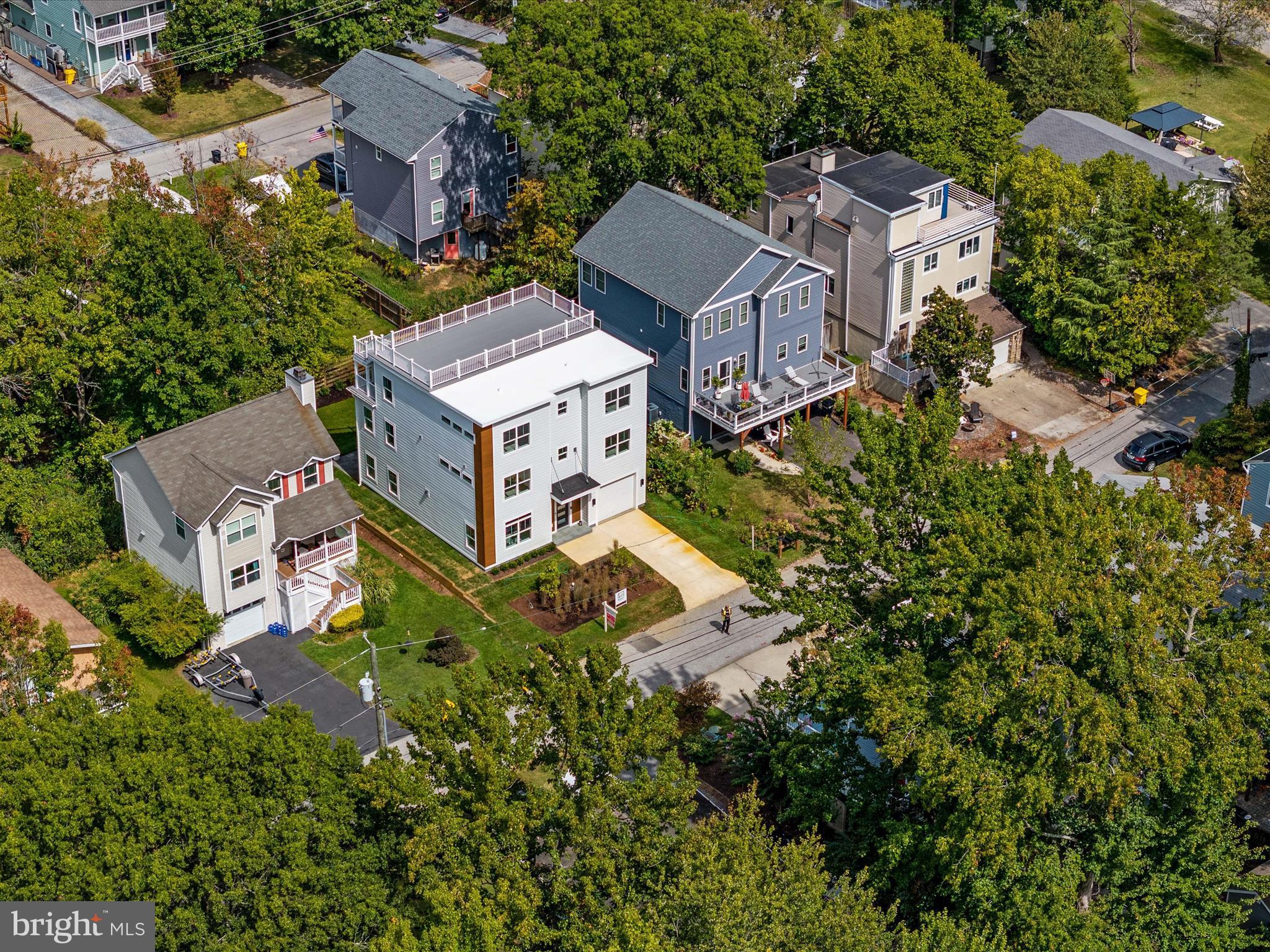 an aerial view of residential house with an outdoor space and seating