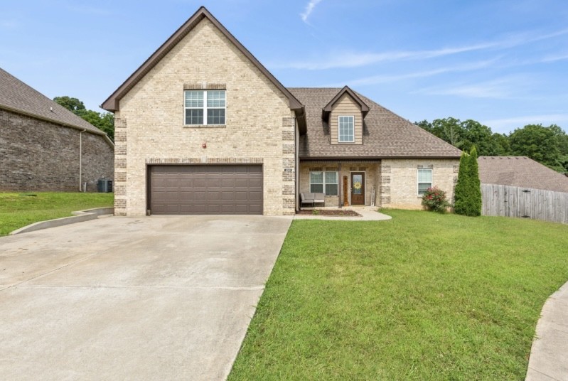 a front view of a house with a yard and garage