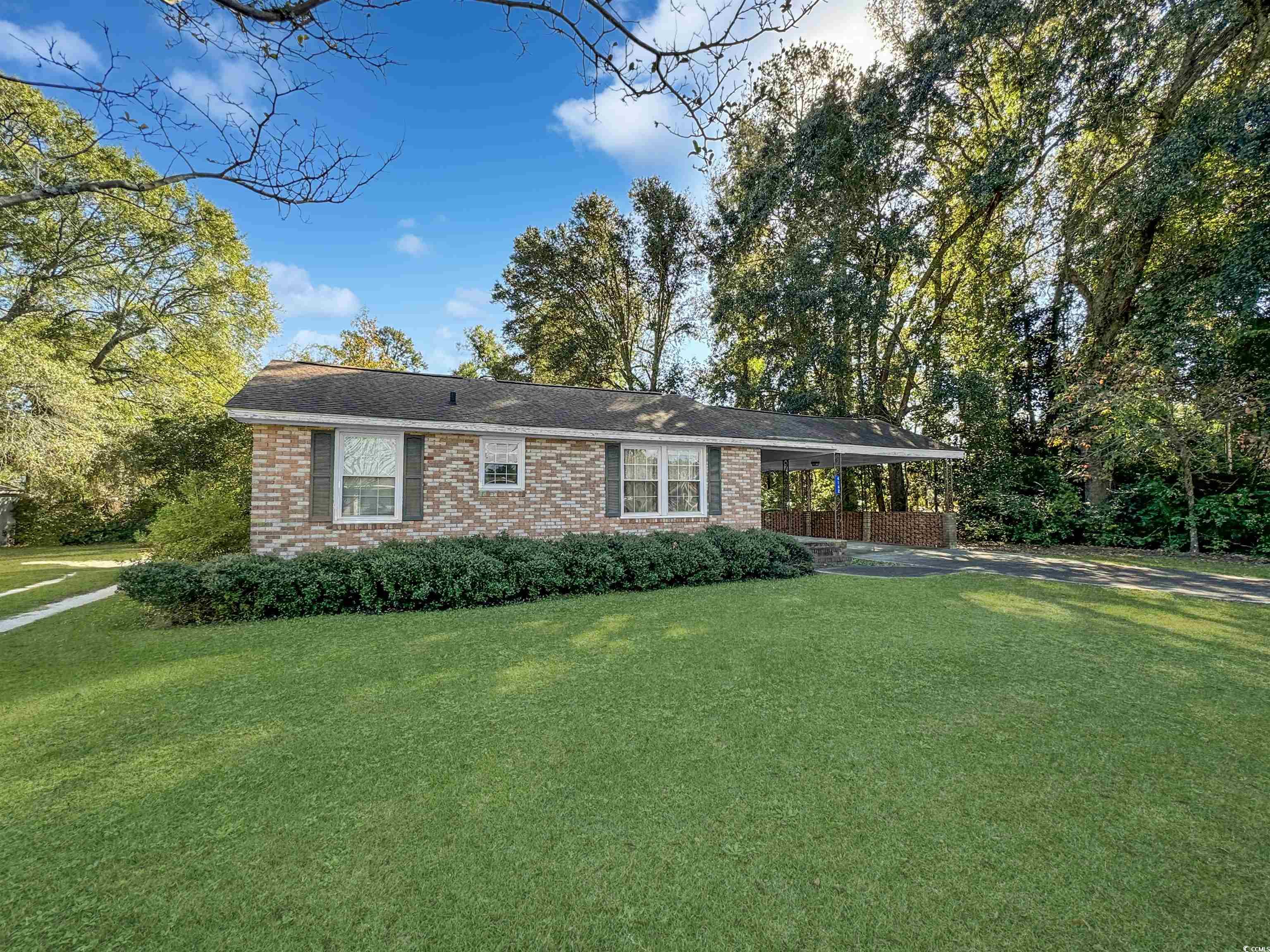 Ranch-style house featuring a front lawn