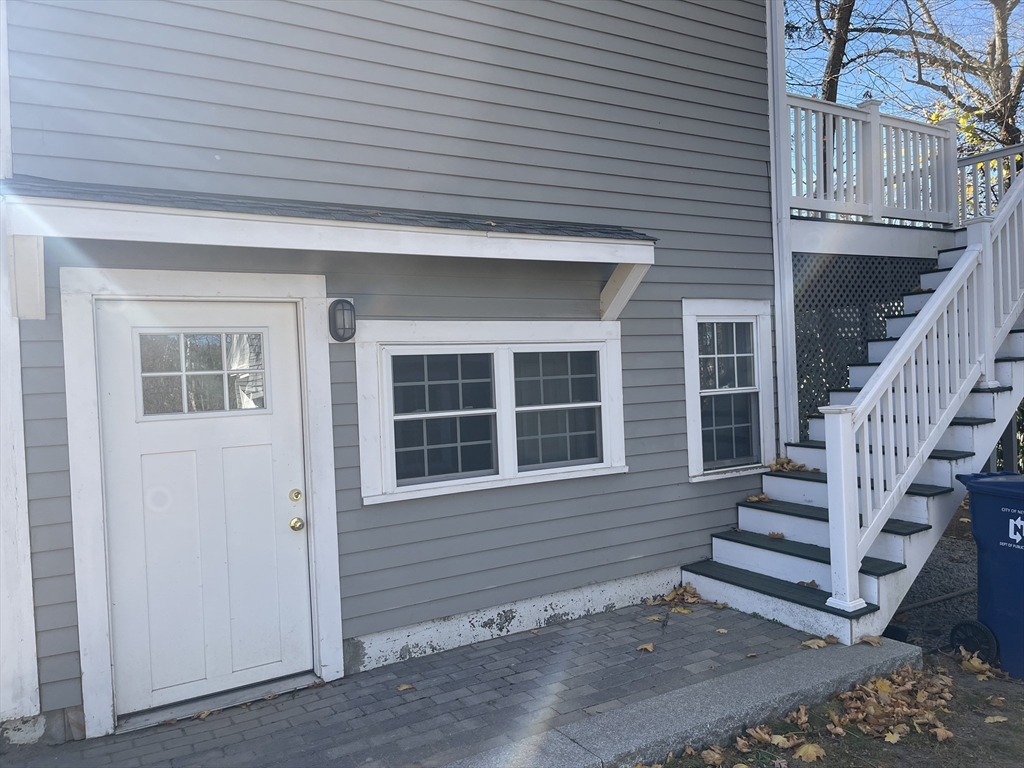 a view of house with stairs and wooden fence