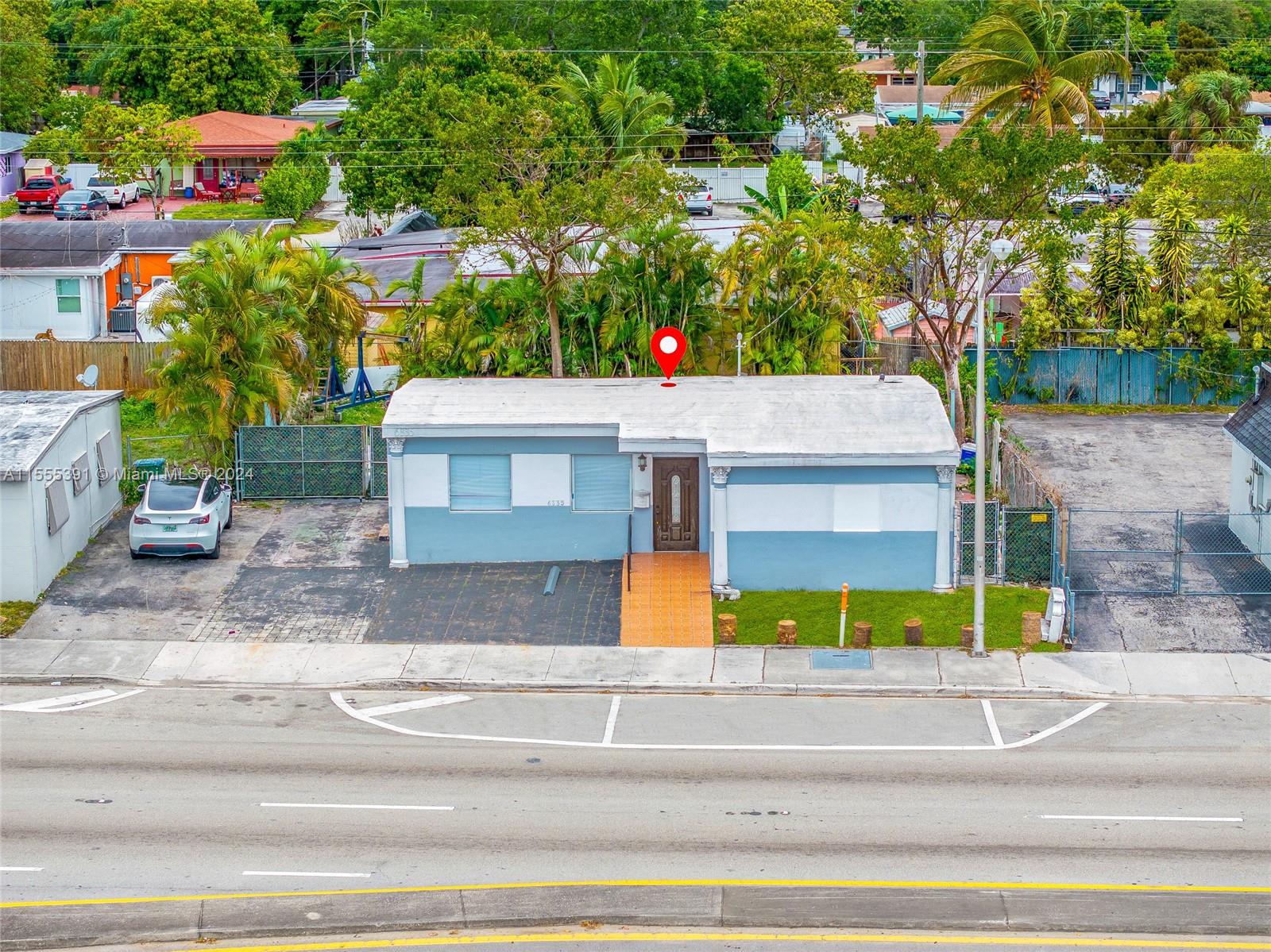 a view of a house with a yard and tree s