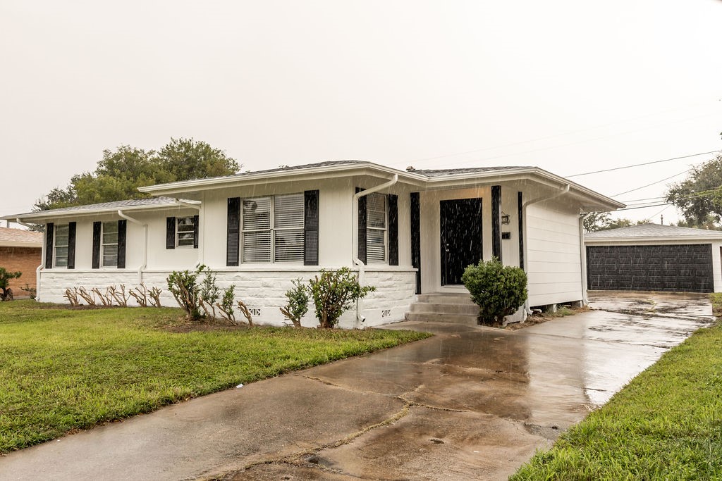 a front view of house with yard and green space