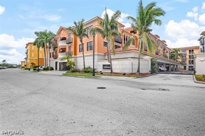 a front view of multiple house with palm trees