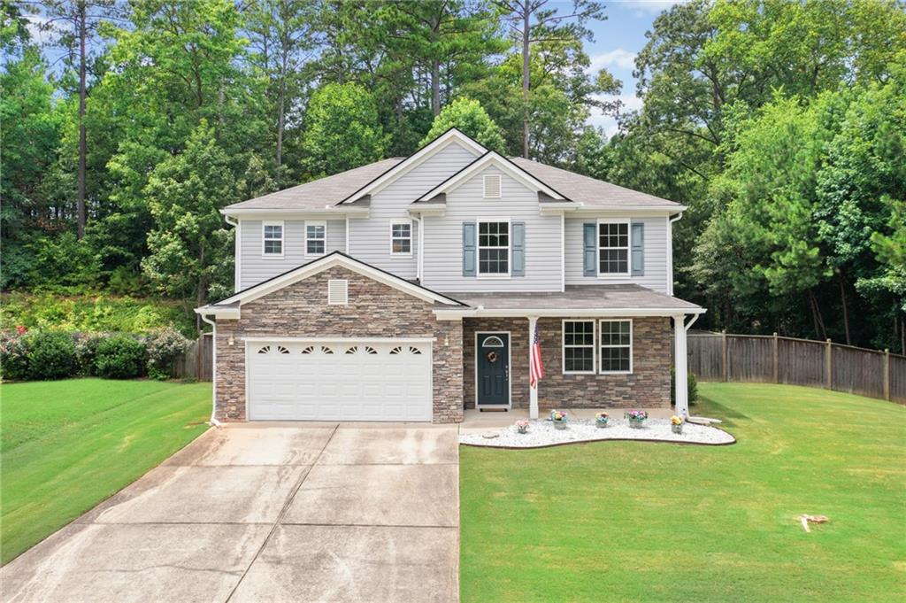 a front view of a house with yard