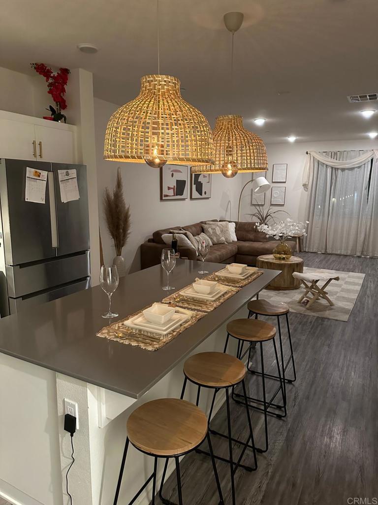 a kitchen with a table chairs and a wooden floor