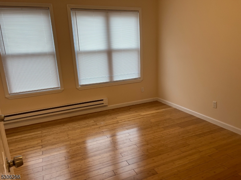 a view of a room with wooden floor and window