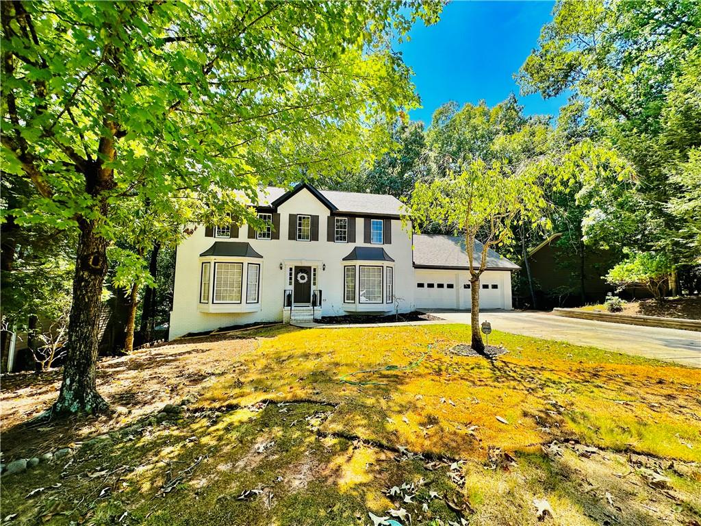 a front view of a house with a yard