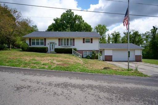 a front view of a house with a garden and yard