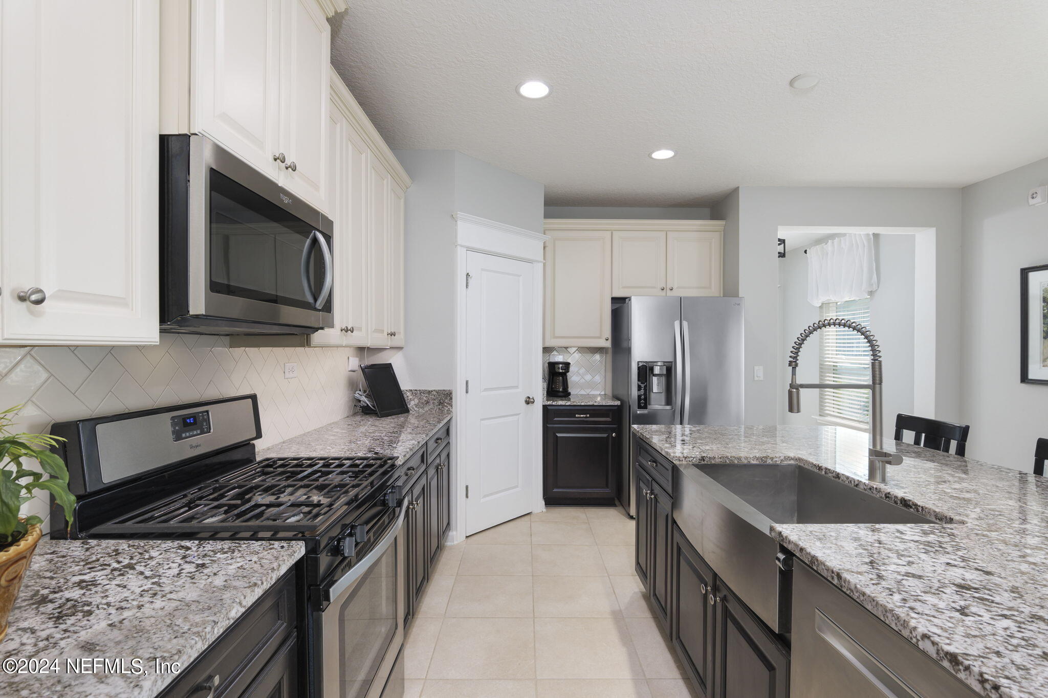 a kitchen with granite countertop stainless steel appliances and sink