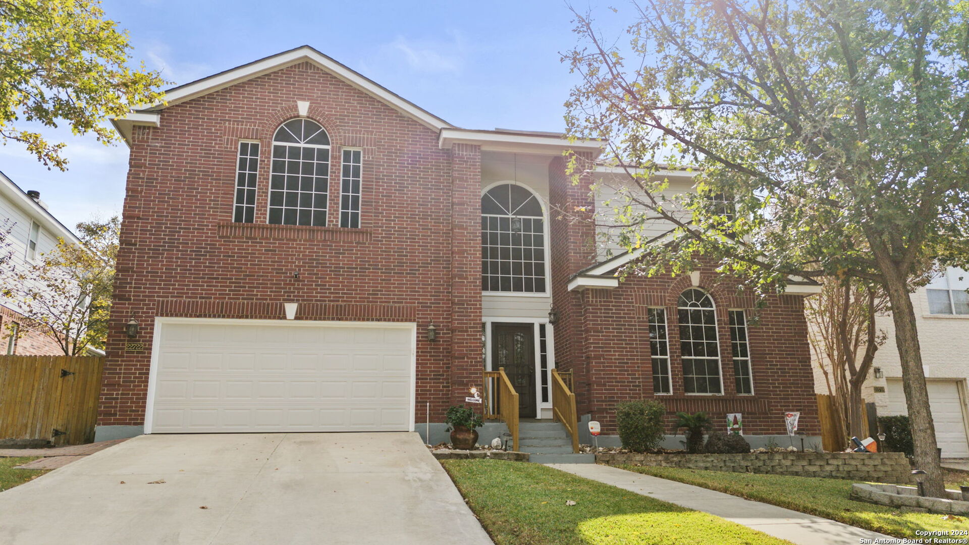 a front view of a house with yard and garage