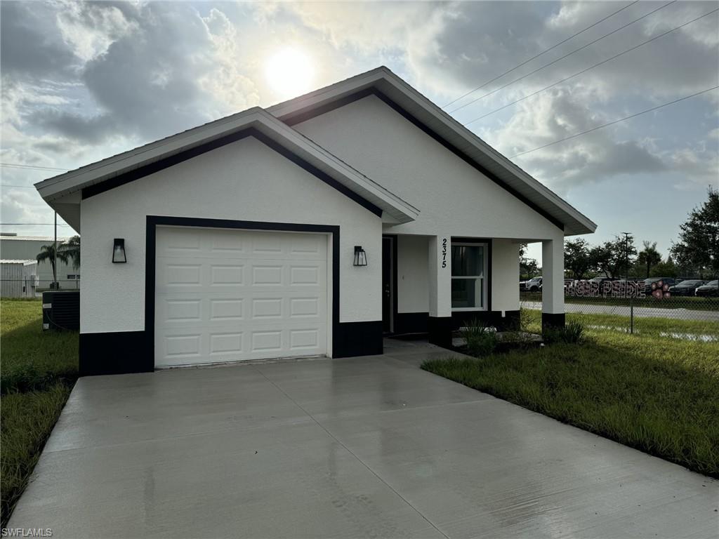 a front view of house with yard and green space