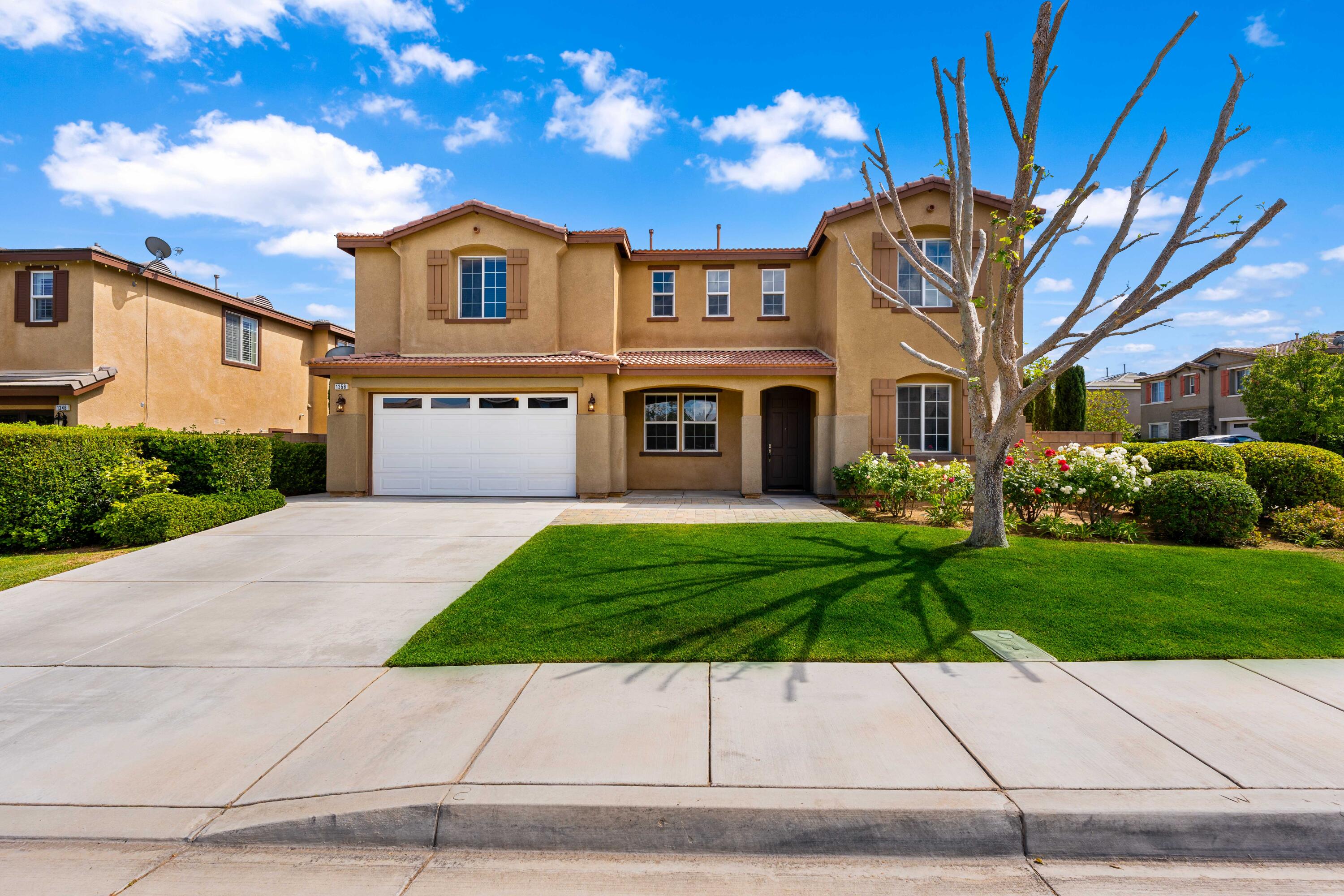 a front view of a house with a yard and a garage