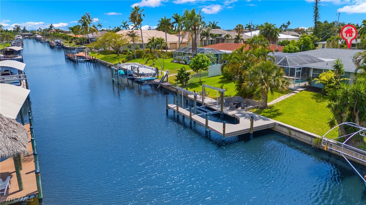 an aerial view of a house with outdoor space swimming pool and lake view