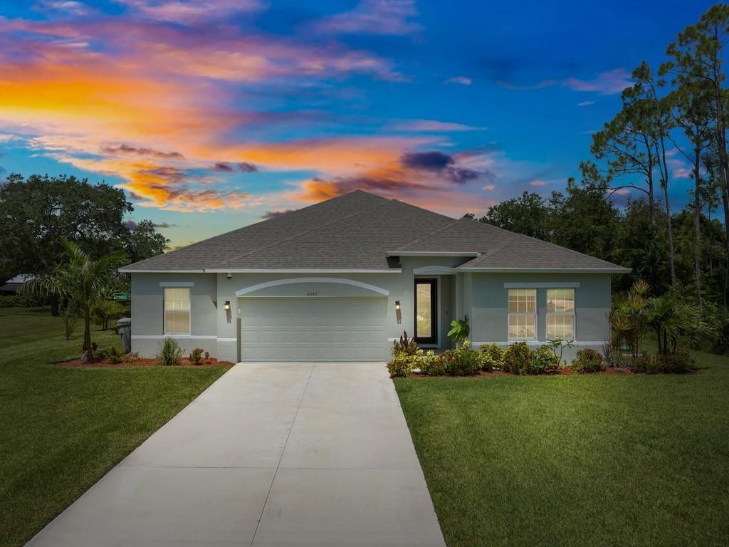 a front view of a house with a garden