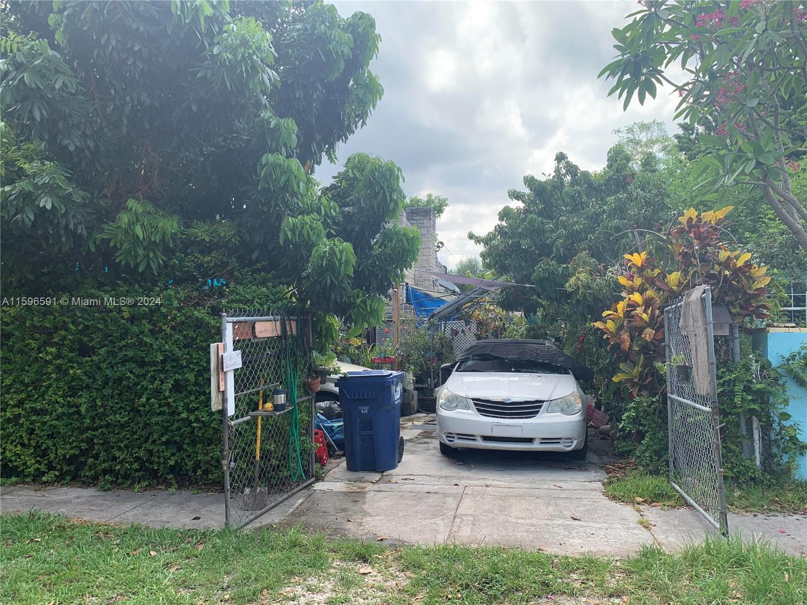 a car parked in front of a house and trees