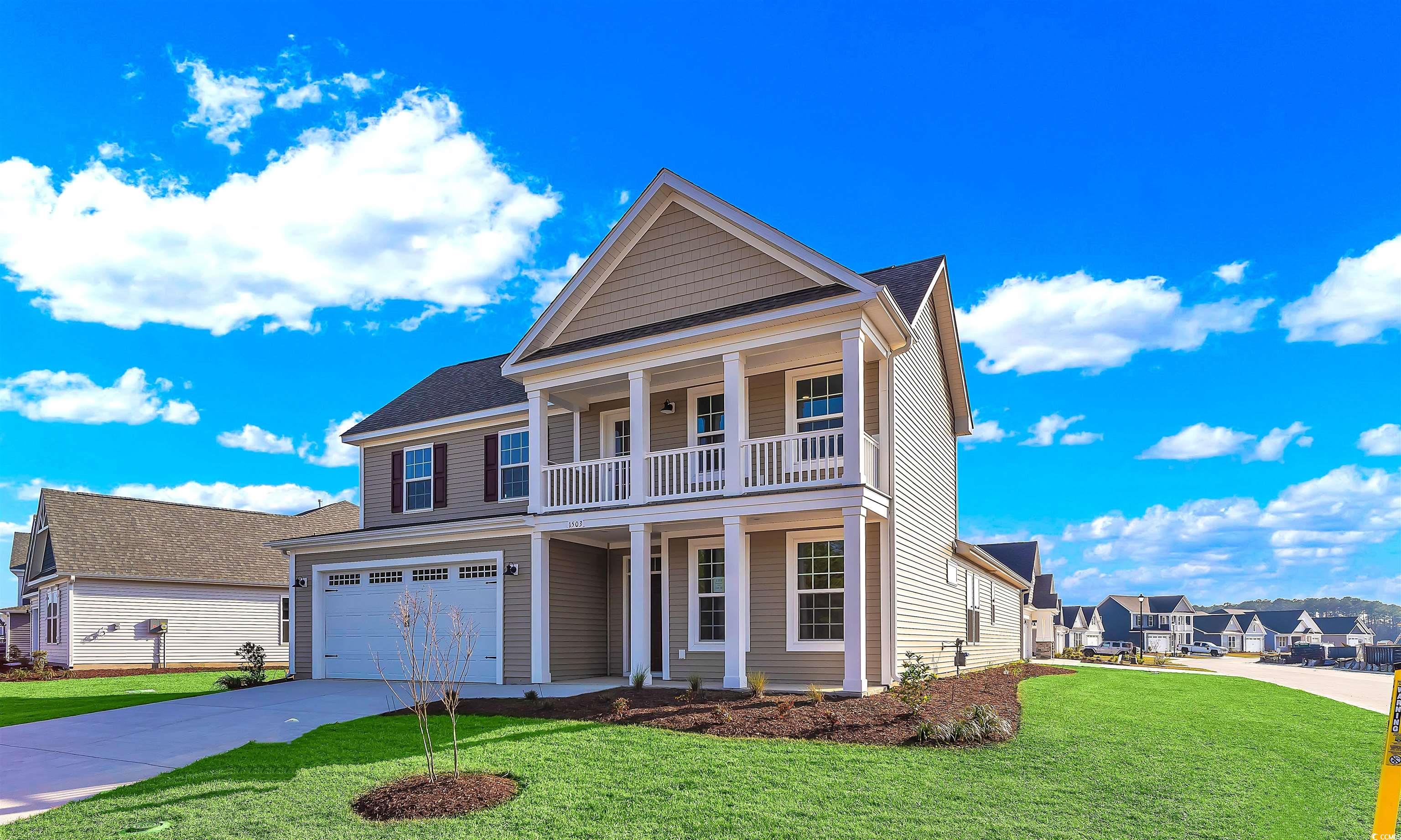 View of front of property featuring a garage, a ba