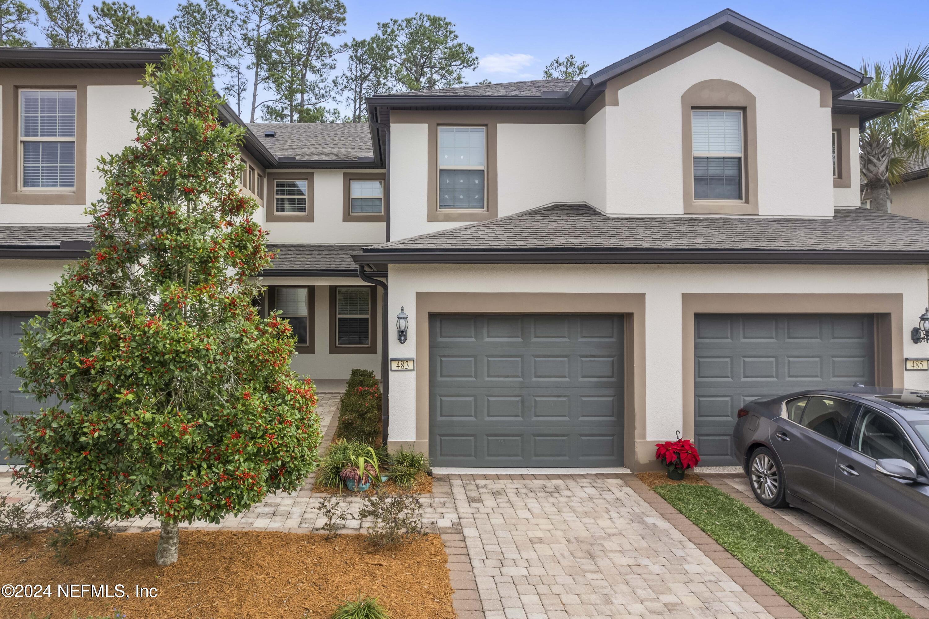 a front view of a house with a garden