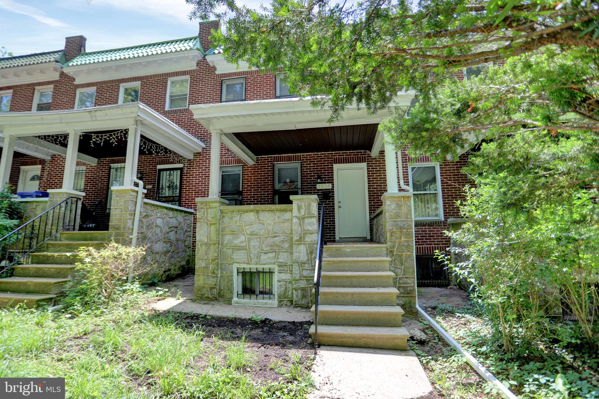 a front view of a house with plants