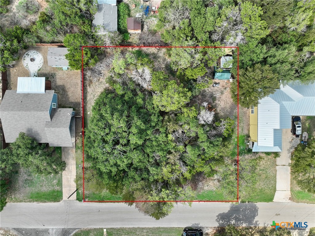 an aerial view of a house with a yard and garden