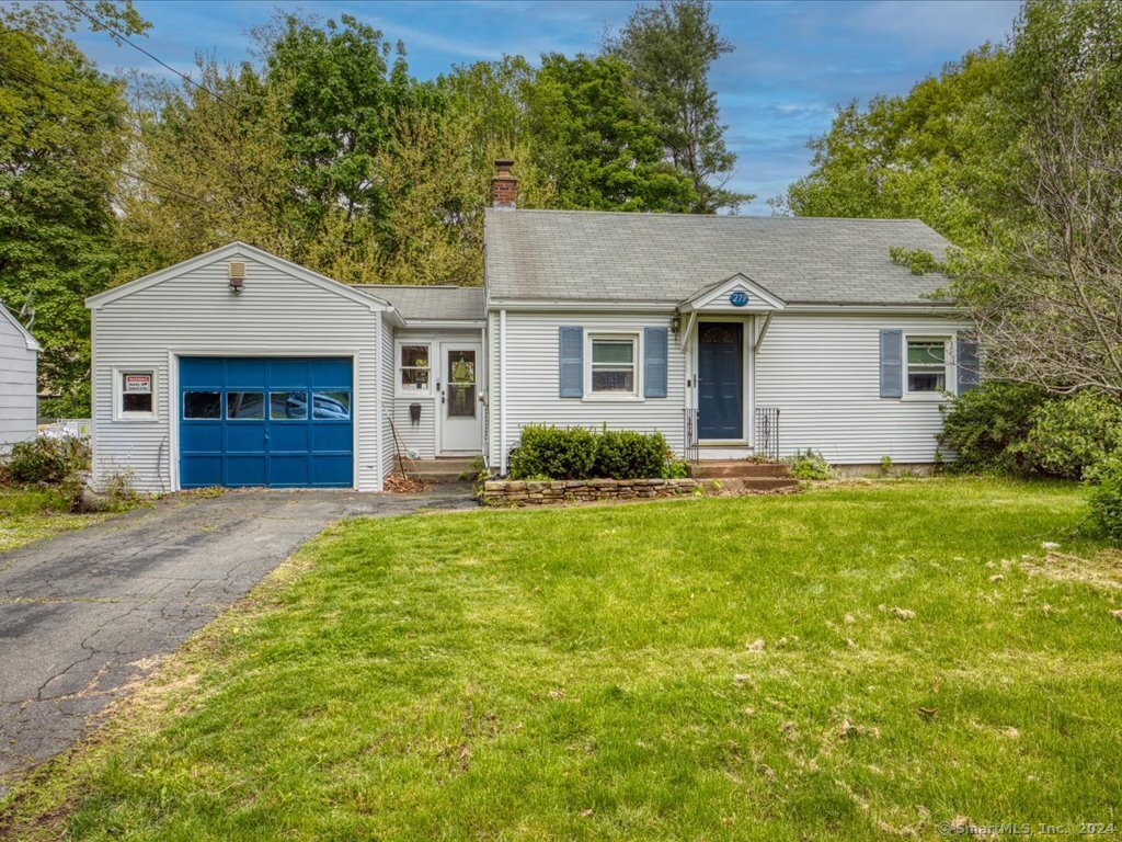 a front view of a house with yard and green space