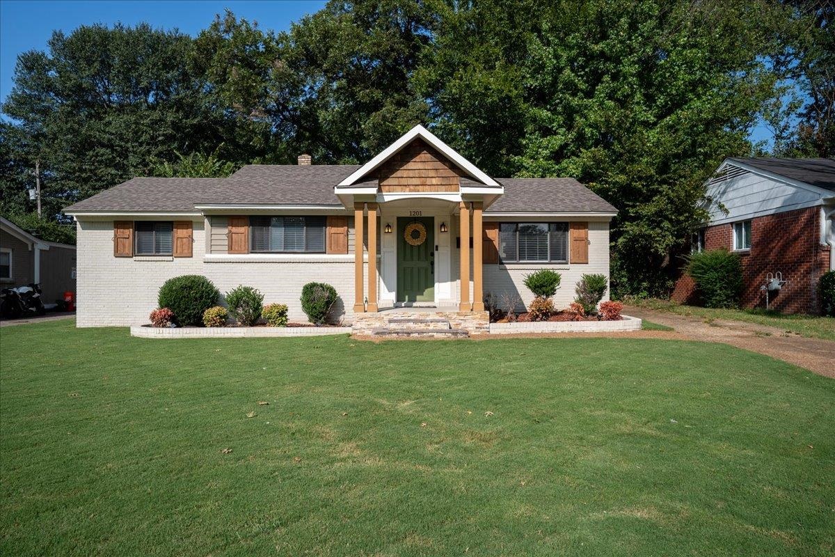 a front view of house with yard and green space