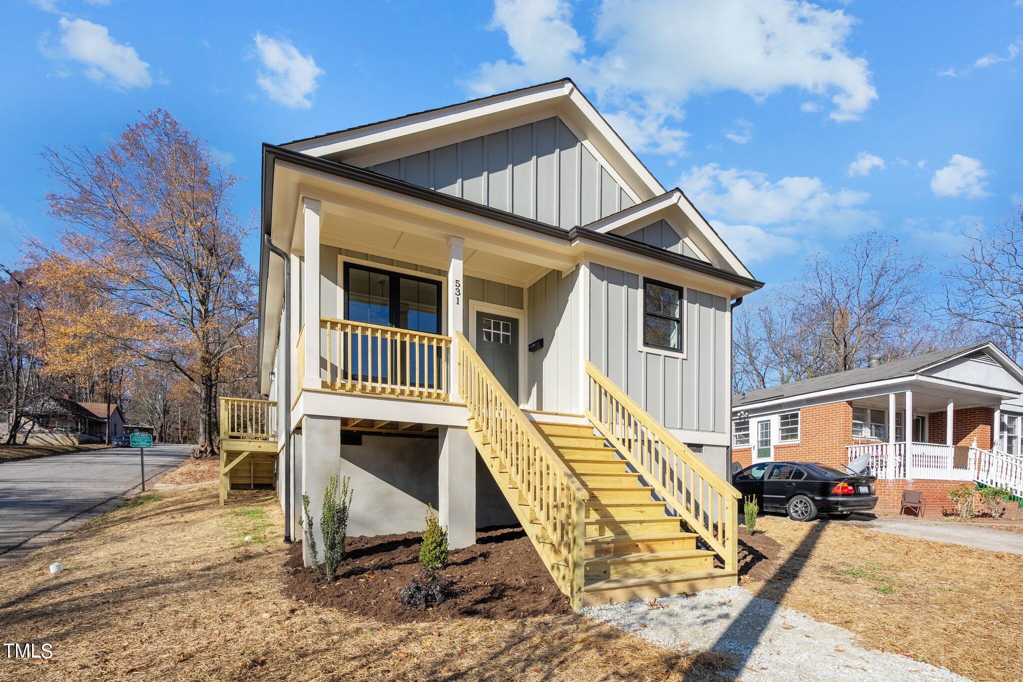 a view of a house with backyard and porch