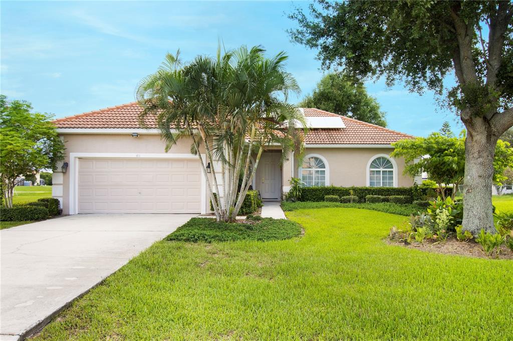 a front view of a house with a yard and garage