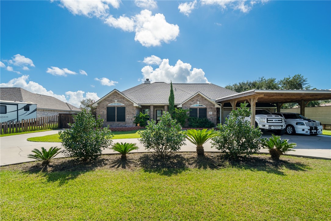 a front view of house with yard and swimming pool