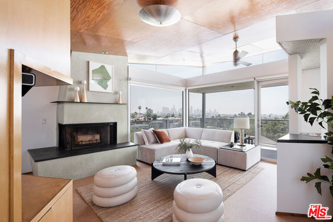 a living room with furniture and a fireplace