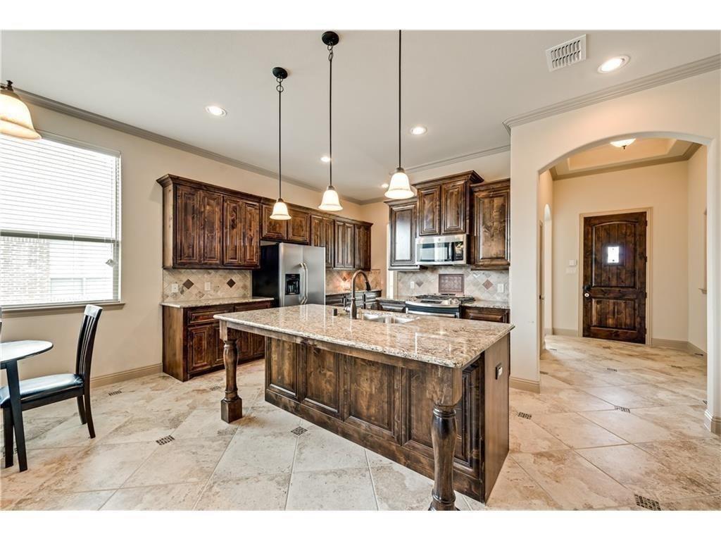 a large kitchen with cabinets table and chairs