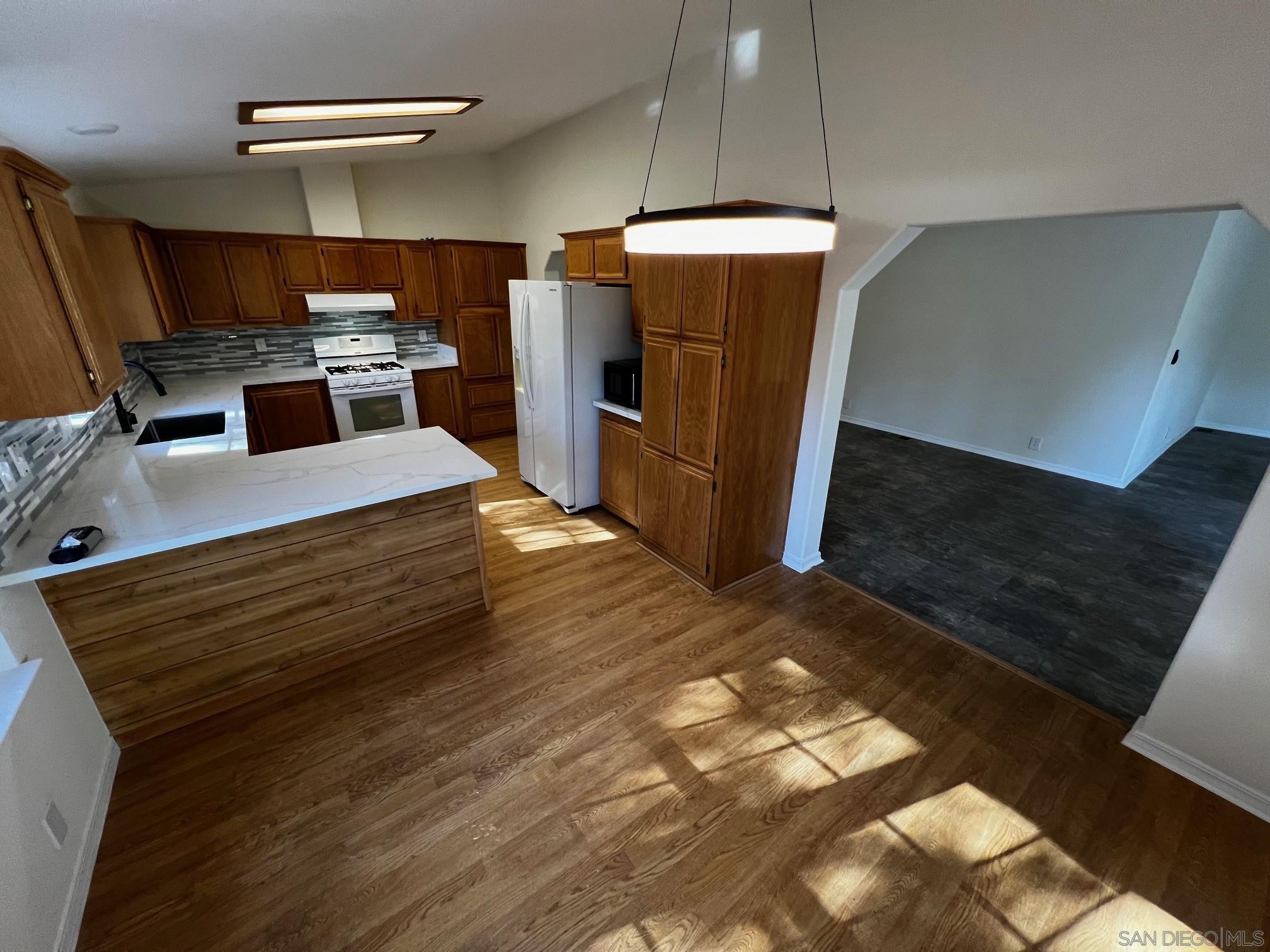 a kitchen with refrigerator and microwave