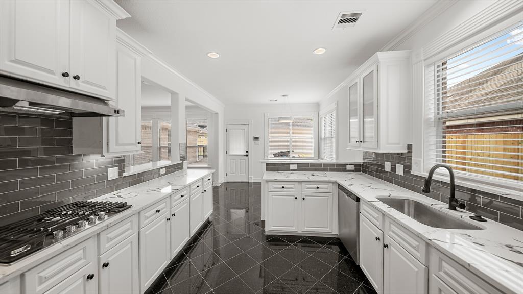 a kitchen with a sink stove and cabinets