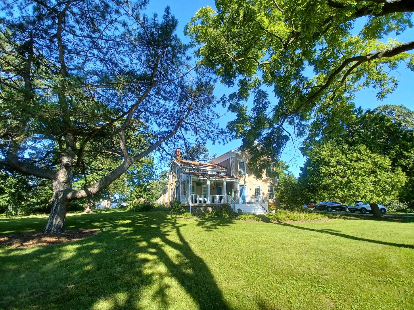 a front view of house with yard and green space