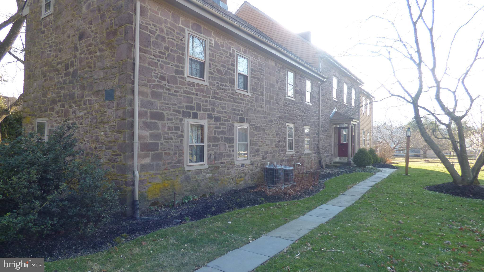 a view of a brick building next to a yard