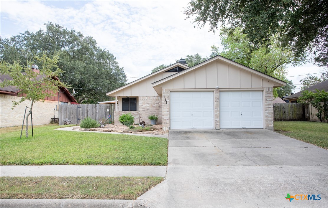 a view of a house with a yard and garage