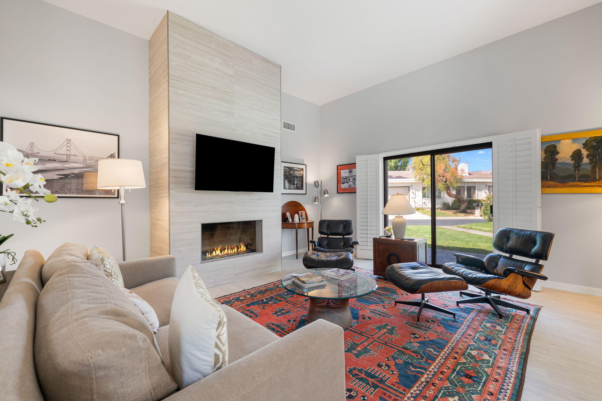 a living room with furniture a flat screen tv and a fireplace