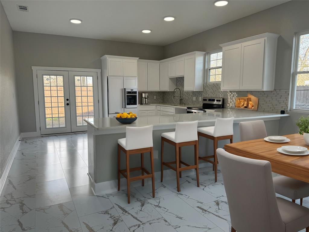 a kitchen with a table chairs sink and cabinets