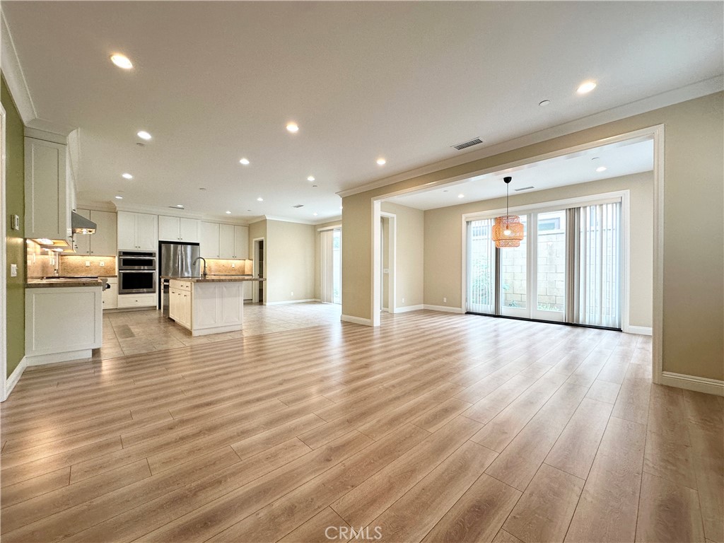 a view of kitchen with furniture and wooden floor