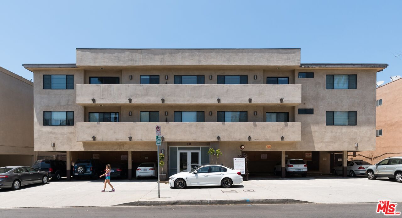 a view of building with cars parked