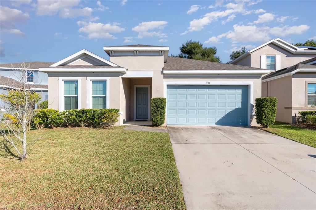 a front view of a house with a yard and garage