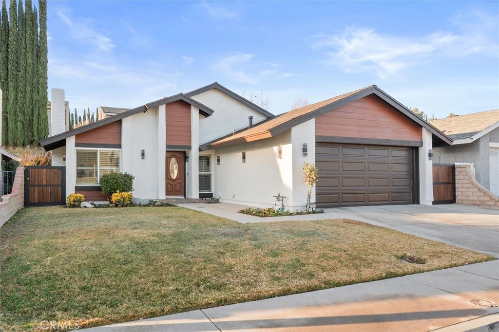 a view of a house with a yard and garage